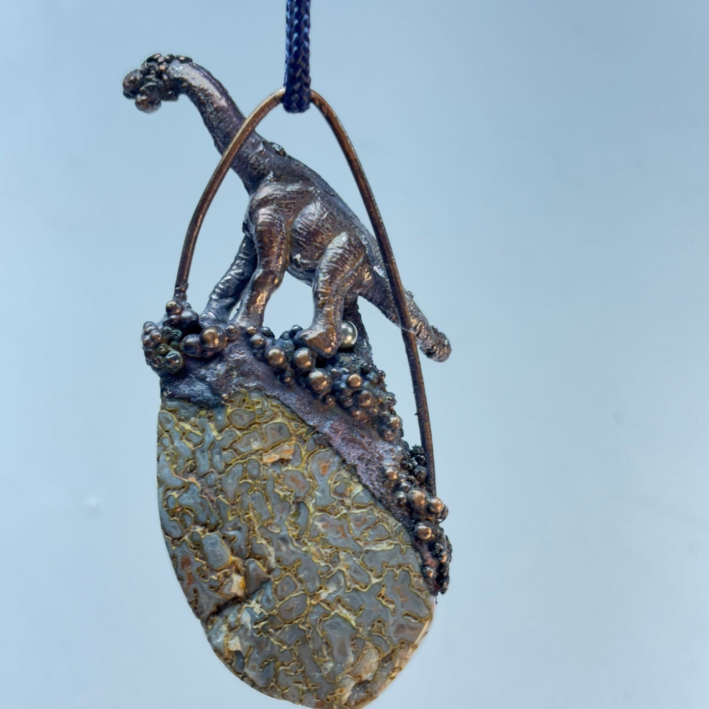 Dino on Dino! Petrified Dinosaur Bone Pendant with Sauropod